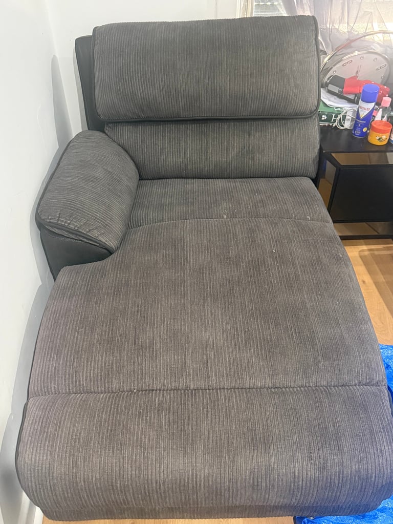 Gray upholstered reclining chair before cleaning
