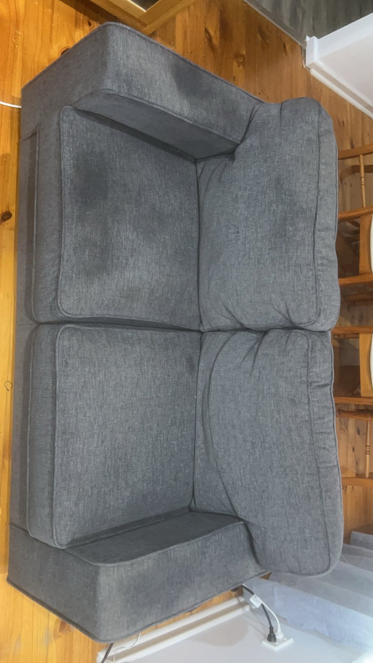Gray upholstered armchair before cleaning