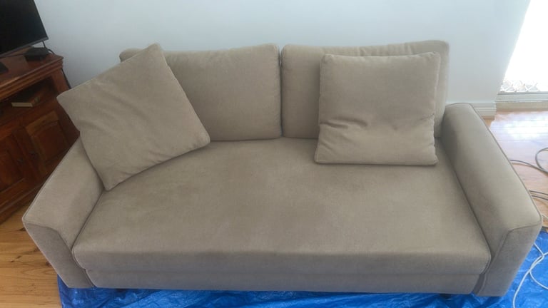 Beige upholstered sofa before cleaning
